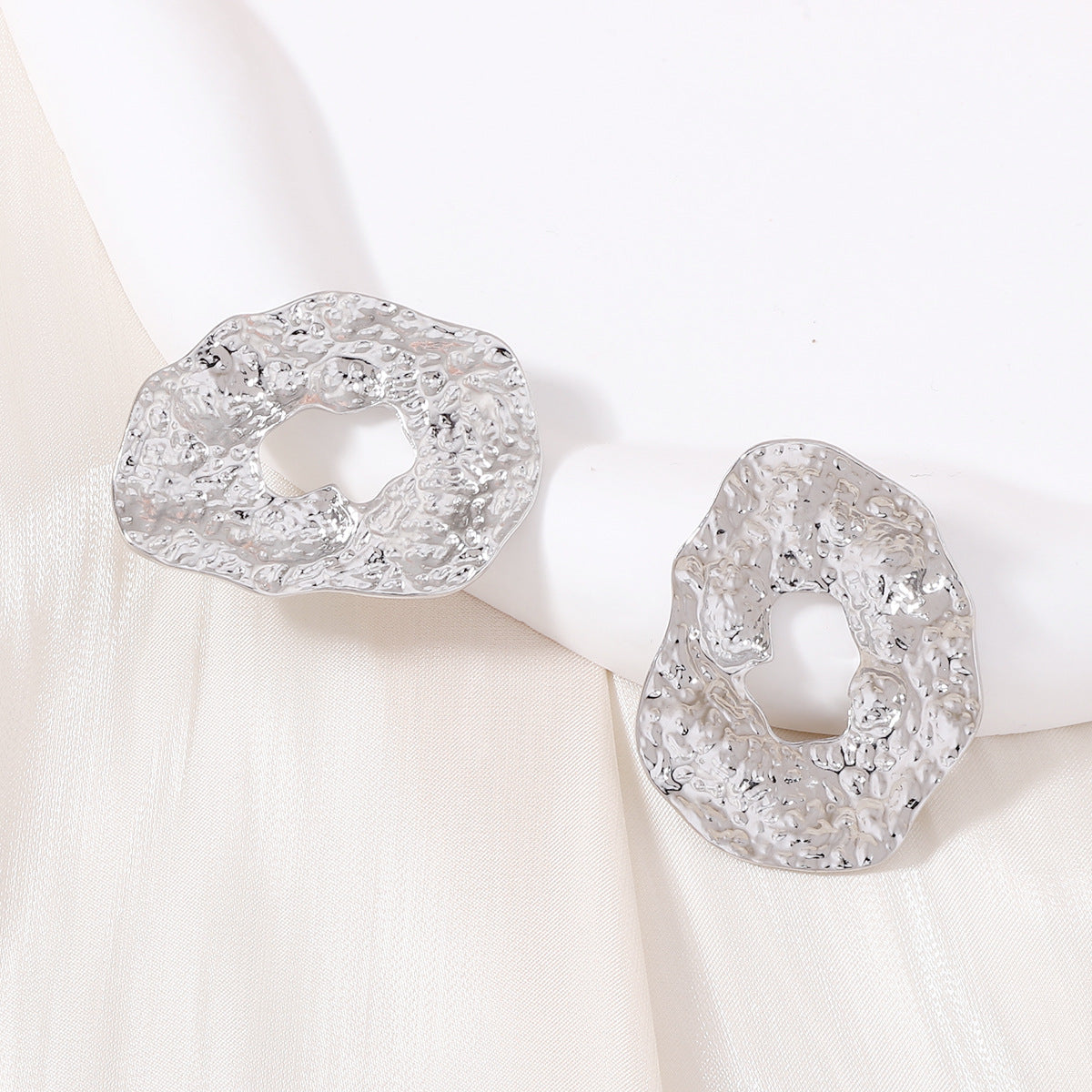 Stylish Geometric Irregular Oval Metal Earrings with Unique Hollowed Round Design — Eye-Catching Textured Studs for a Chic Look