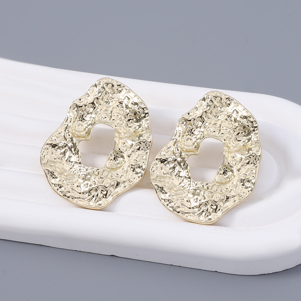 Stylish Geometric Irregular Oval Metal Earrings with Unique Hollowed Round Design — Eye-Catching Textured Studs for a Chic Look
